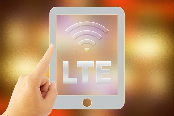 手摸平板"LTE"覆盖模糊的背景 图片素材