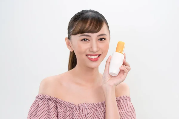 亚洲妇女显示奶油在她的手，孤立在白色 图片素材